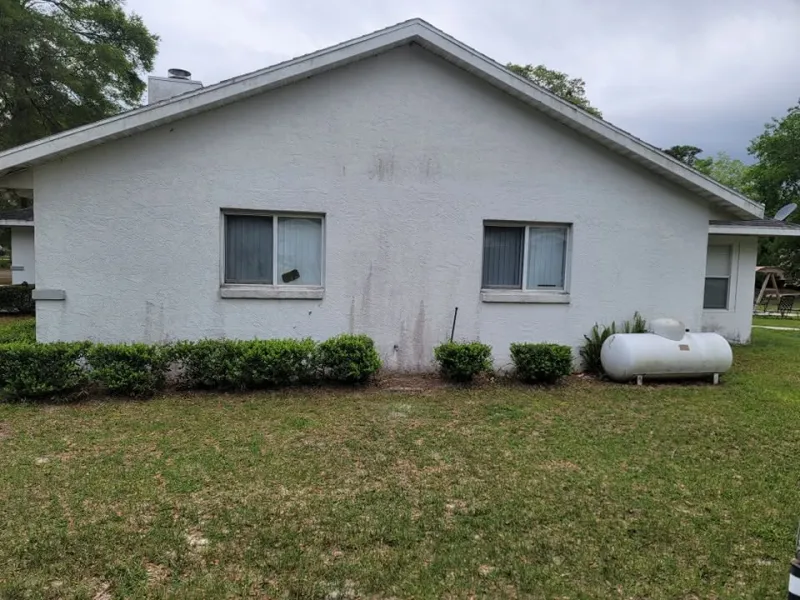 Stucco house siding streaked with mildew
